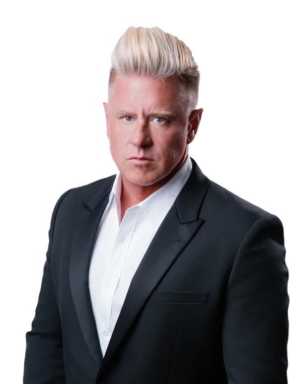J Bravo in a black suit and white shirt
